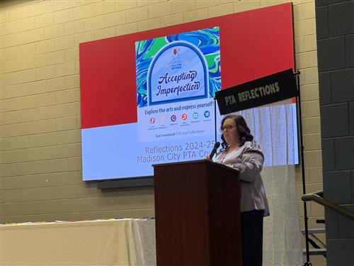 Beth Green, PTA Reflections Contest Co-Chair, standing at podium